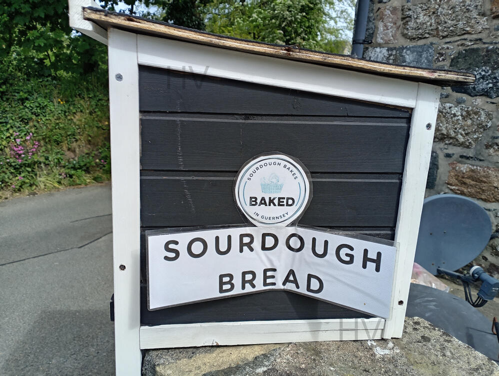 Hand made Sour Dough Bread on a honesty stall wooden shed surrounded by roses
