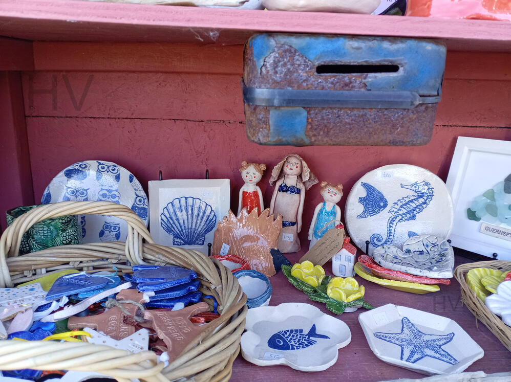road side plants for sale. Drop money in letter box. wooden shed surrounded by roses